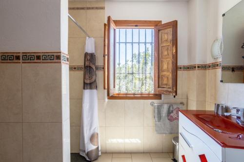 a bathroom with a red sink and a window at Apartment Luna in Salobreña