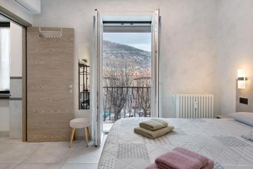 a bedroom with a large bed and a balcony at Double room - Myaostaproject in Aosta