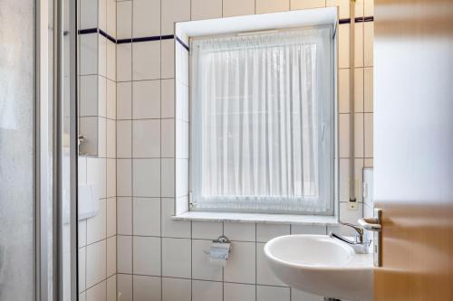 a bathroom with a sink and a window at Ferienwohnung Tannenblick 3-2 in Oberhof