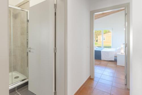 a bathroom with a shower and a glass door at Paraiso da Serva - Flor do Rosto 2 in Odemira
