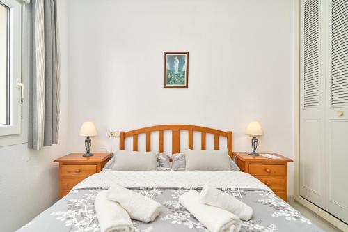 a bedroom with a large bed with two night stands at Ferienwohnung Peñoncillo in Torrox