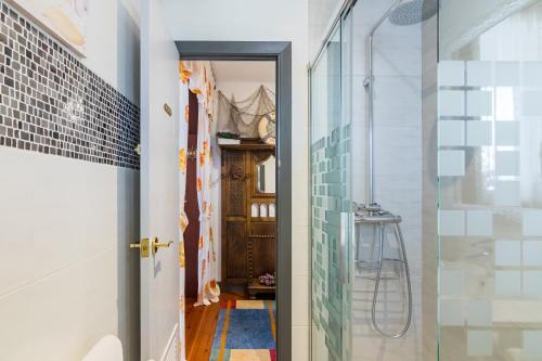 a bathroom with a shower and a glass door at Estudio La Barquera in San Vicente de la Barquera