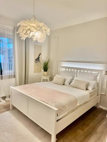 a white bedroom with a large white bed at Ferienwohnung am Olantis in Oldenburg