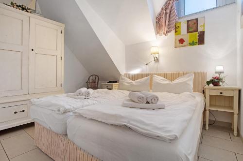 a bedroom with two beds with towels on them at Wellness-Residenz Wohnung 19 in Zingst