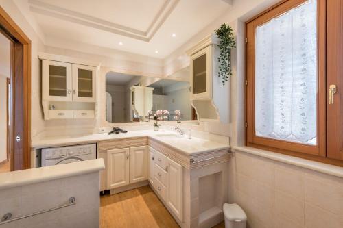 a bathroom with a sink and a large mirror at Passioncasa in Torri del Benaco