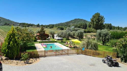 a villa with a swimming pool in a garden at Solar Rubina - Piscina Água Salgada in Belmonte