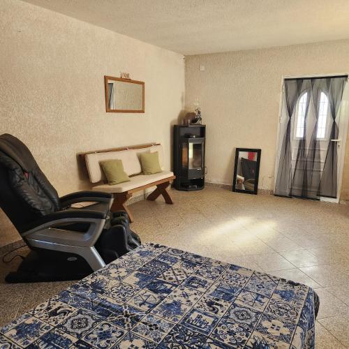 a room with a bed and a chair and a table at Solar Rubina - Piscina Água Salgada in Belmonte