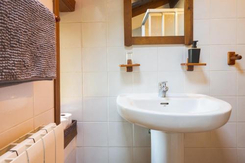 a bathroom with a white sink and a mirror at Pagorriaga in Beasain
