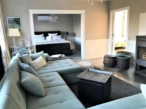 a living room with a couch and a bed at Haus Sonnenschein in Janneby