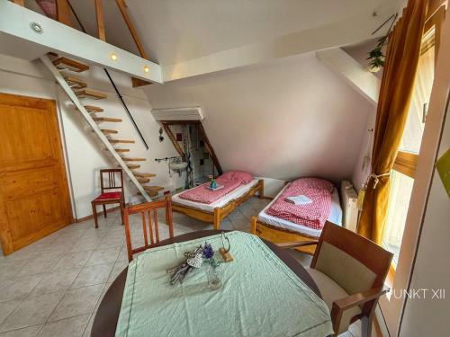 a room with a staircase and a table and chairs at Wohnung 2 in Burghaslach