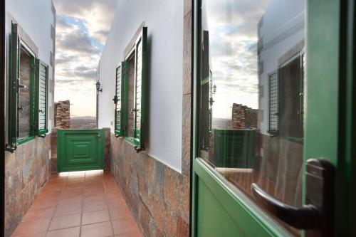 a balcony with green windows and a green door at Casa Dayaday in Puerto del Rosario
