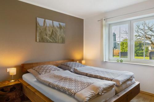 two beds in a bedroom with a window at Ferienwohnung Dora in Medebach
