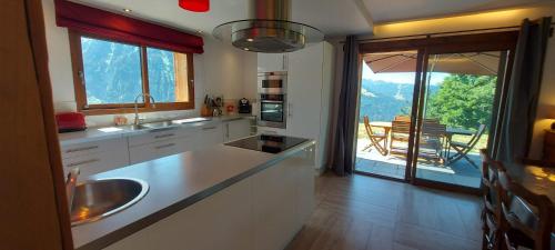 a kitchen with a sink and a view of a table at Morzine Panoramic in Morzine