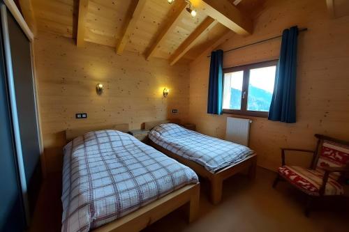 a room with two beds in a log cabin at Morzine Panoramic in Morzine