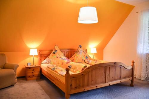 a bedroom with a wooden bed with pillows on it at Ferienwohnung Moog in Steinach