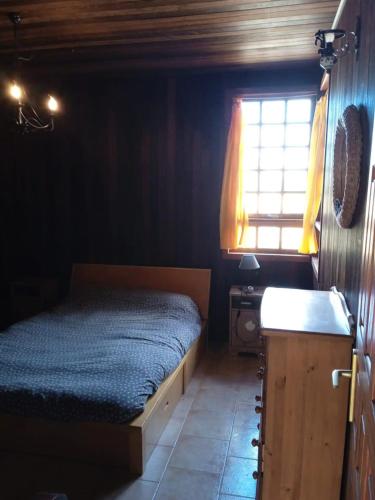 a bedroom with a bed and a sink and a window at Chalet Rural Marian in Santa Maria de Guia de Gran Canaria