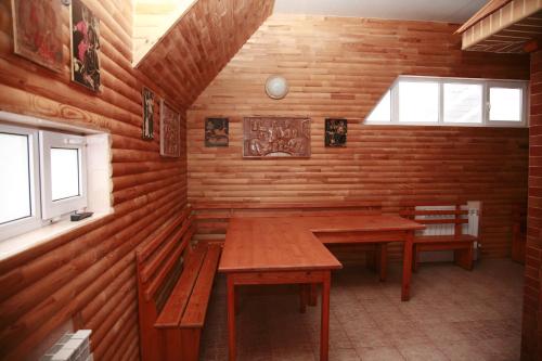 a dining room with wooden tables and benches in a cabin at Sava Dream in Zhytomyr