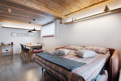 a bedroom with a bed and a table in it at Casa Nadia in Verceia