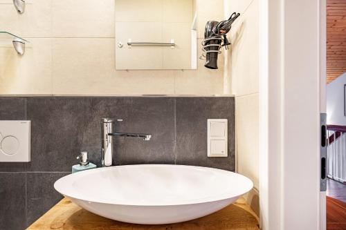 a bathroom with a large white tub in a room at Himmelblau in Schönwald
