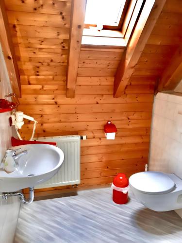 a bathroom with a white sink and a toilet at Gästehaus Bettina in Sipplingen