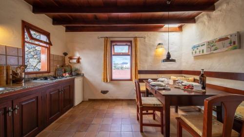 a kitchen with a table and a dining room at Casa Margarita 4 in Mala