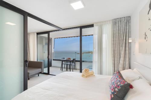 a bedroom with a bed and a view of the ocean at Ocean wave retreat in Patalavaca