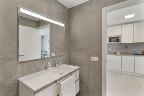 a bathroom with a sink and a mirror at Ocean wave retreat in Patalavaca