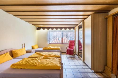 a room with two beds and a window at Große Ferienwohnung Wagner in Wehingen