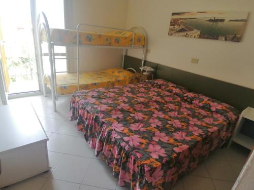 a bedroom with a bed and a bunk bed at Euroholiday Village 1G in Lido di Jesolo