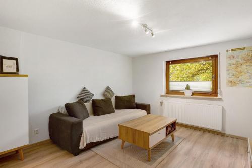 a living room with a couch and a table at Fewo Schober in Kirchhundem