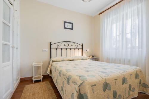 a bedroom with a bed and a large window at Brizna in Oreña