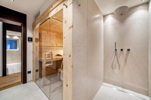 a bathroom with a shower with a glass door at Schenna Chalet - Apt Dora in Schenna