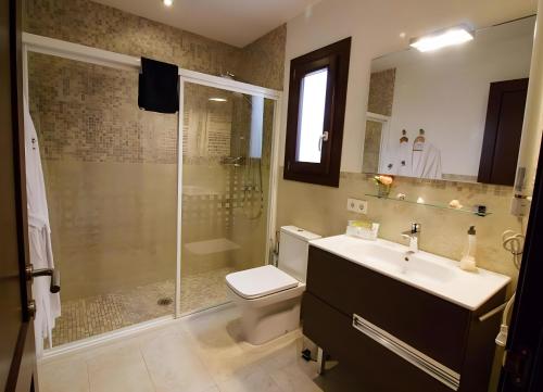 a bathroom with a shower and a sink and a toilet at Pescadores in Cala Ratjada