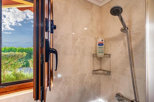 a shower in a bathroom with a window at Apto Amarillo - Casa el gaitero in Susacasa