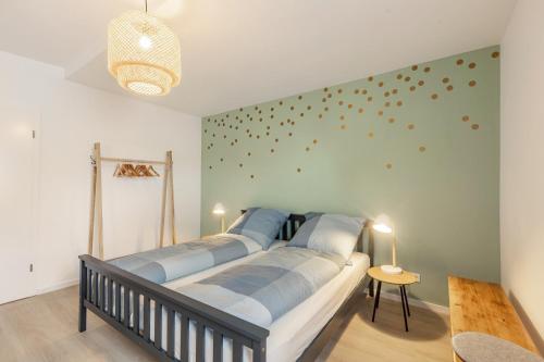a bedroom with a bed with blue pillows on it at Höhe26 in Bad Vilbel