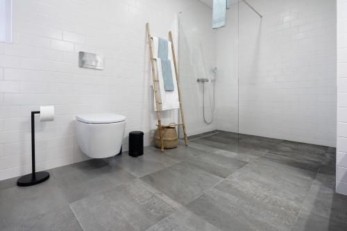 a bathroom with a toilet and a shower at Rocha do Mar 2 in Biscoitos