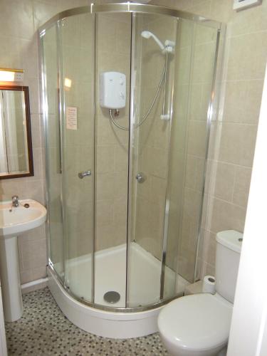 a bathroom with a shower with a toilet and a sink at The Monsell Hotel in Skegness