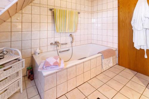 a bathroom with a bath tub with a towel at Ferienwohnung Birkenberger in Löffingen