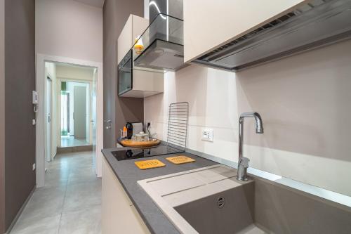 a kitchen with a sink and a counter top at La Casetta del Cuore in Noto