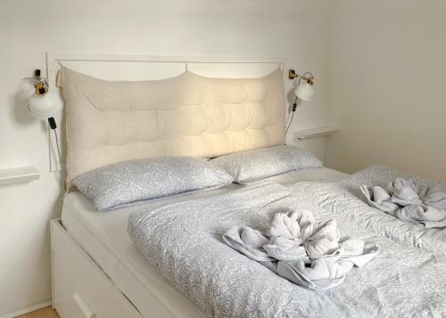 a white bed with two pillows on it at Fewo Seehaase in Radolfzell am Bodensee