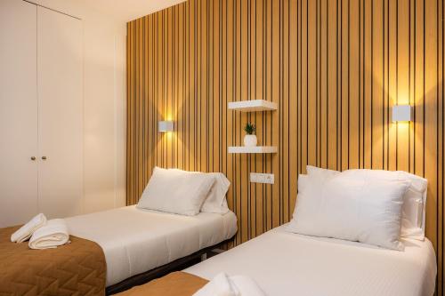 a hotel room with two beds and two lamps at First Line Mediterranean Apartment in Calvià