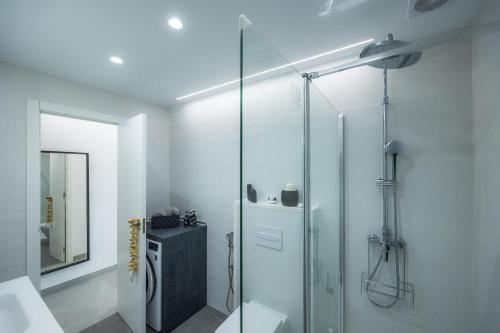 a bathroom with a shower with a glass door at First Line Mediterranean Apartment in Calvià