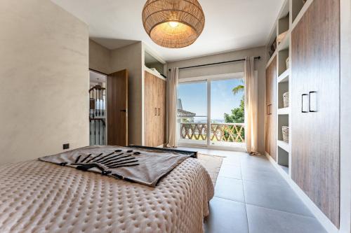 a bedroom with a large bed and a large window at Casa Rocas in Mijas