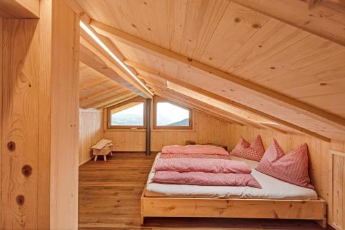 a room with two beds in a wooden house at Ratscheinerhof App Waldruhe in Lazfons
