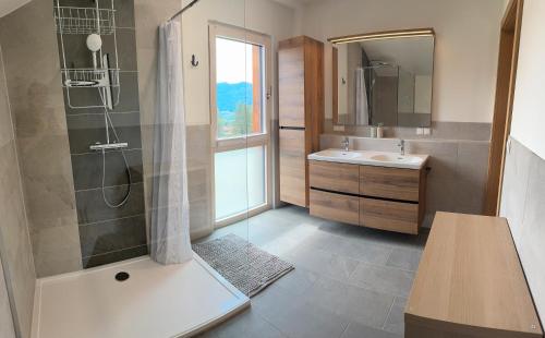 a bathroom with a shower and a sink at Landhaus Steinrose in Bodensdorf