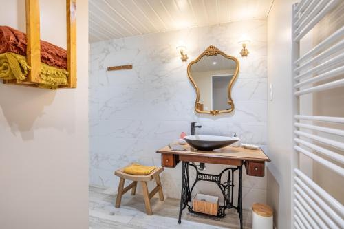 a bathroom with a sink and a mirror at le chai de la lumineuse in Saint-Pierre-dʼOléron