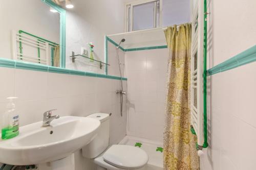 a bathroom with a sink and a toilet and a mirror at La Rana Verde de Arriba in Los Romeros