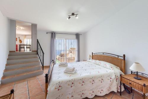a bedroom with a bed and a staircase at Vista al Mar Ainara in Almería