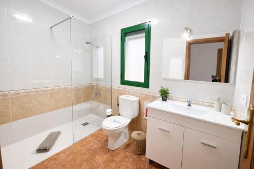 a bathroom with a toilet and a sink and a shower at Kalendra Jable in Guatiza