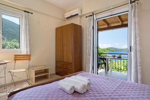 a bedroom with a bed with two towels on it at Vardia studio B in Mikros Gialos